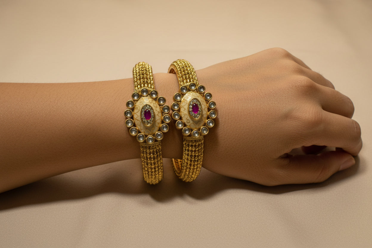 Gold bracelet with gemstones on a fabric background